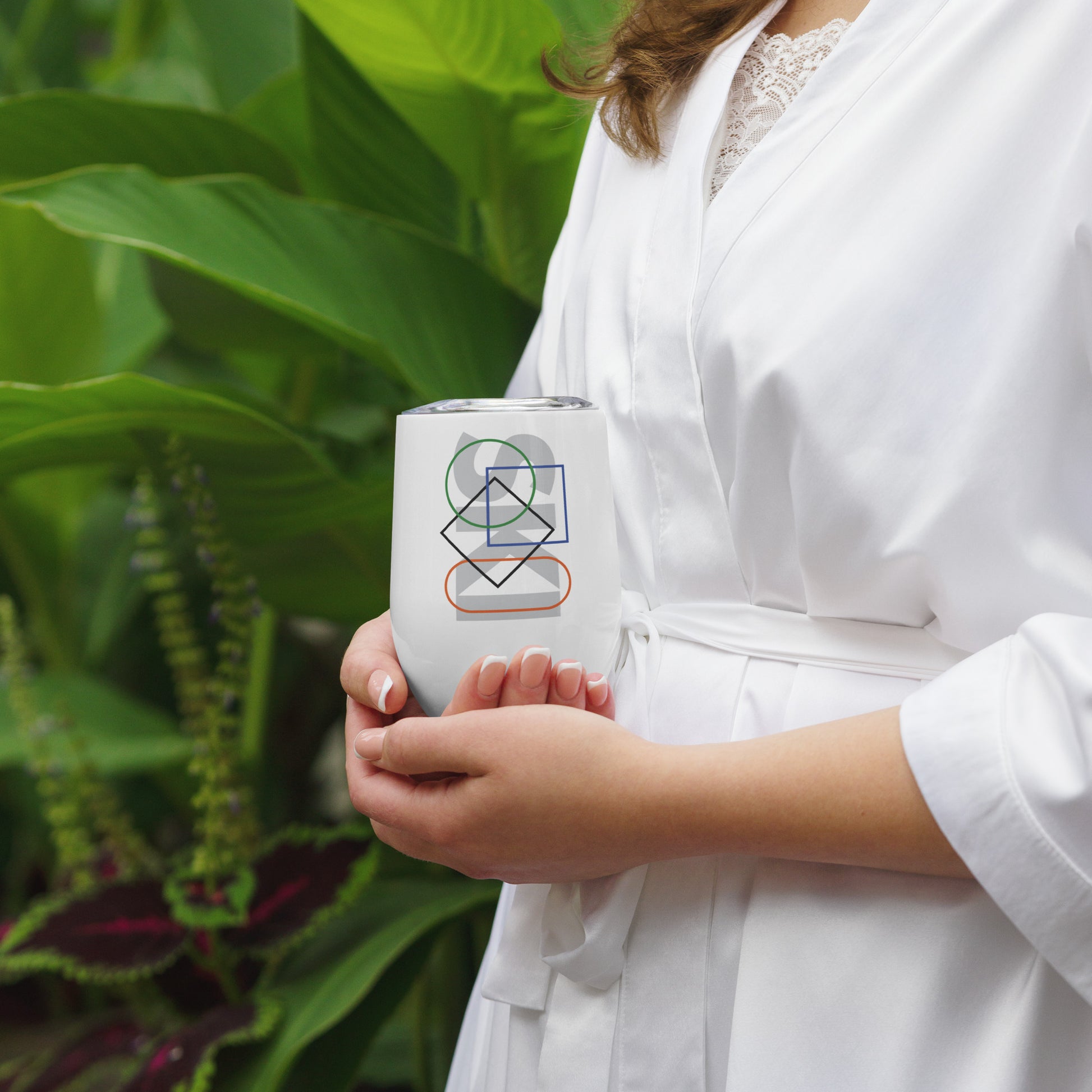 Close up image of woman holding wine tumbler with "Ski Icons Outlined" graphic.