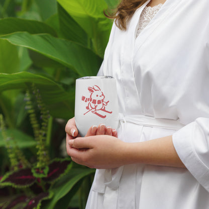 Close up image of woman holding wine tumbler with "Ski Bunny" graphic.