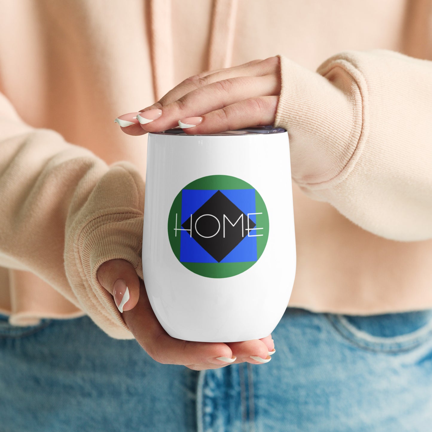 Image of women's hands holding wine tumbler with "Ski Icons Home" graphic.